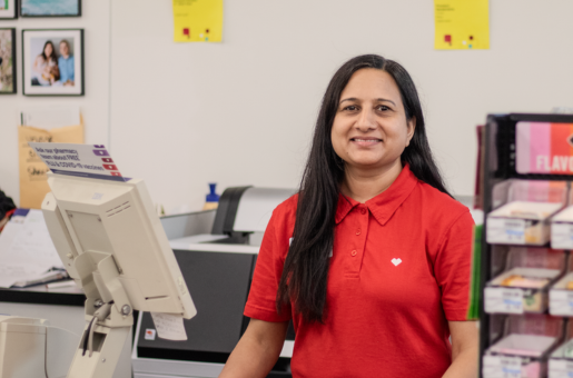 A smiling CVS clerk represented by UFCW Local 880, the retail workers union in Ohio, stands behind the check-out counter.