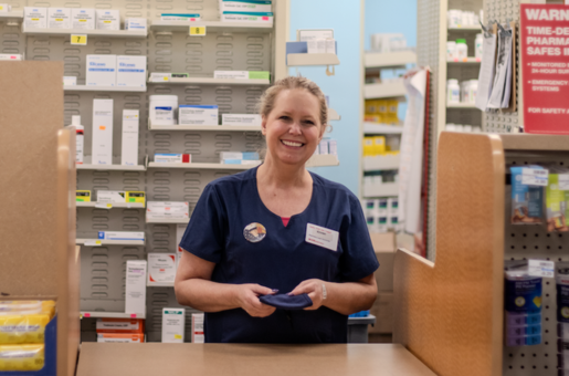 A smiling member of our healthcare workers union at Rite Aid pharmacy.